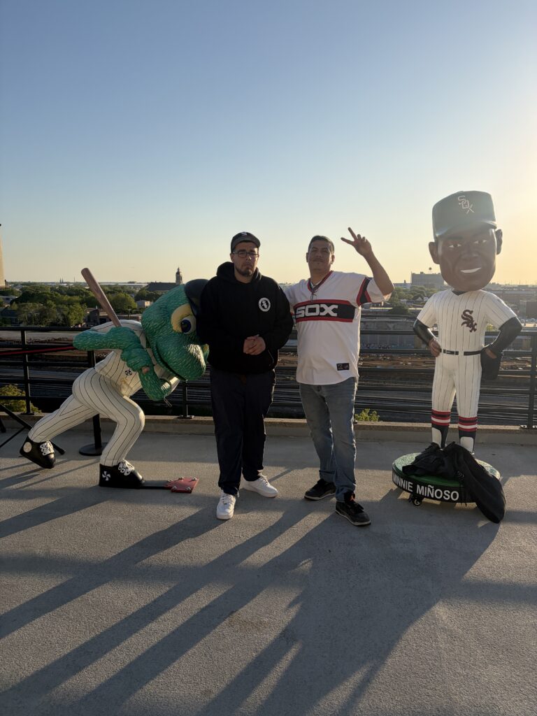 Posing with the giant bobbleheads on the rooftop deck