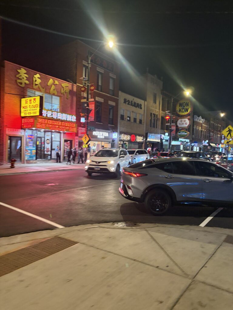 The strip on a Saturday night — energy everywhere, every shop still open.